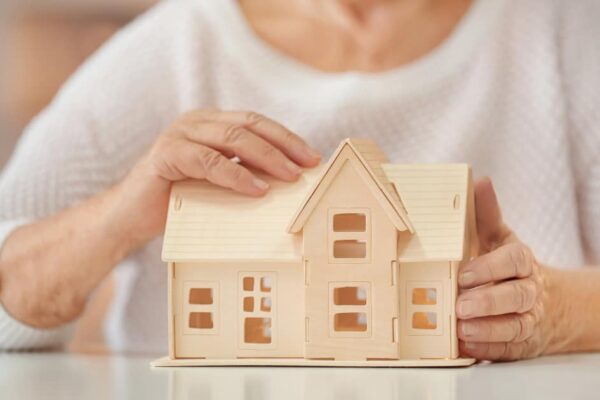 A lady holds a house model