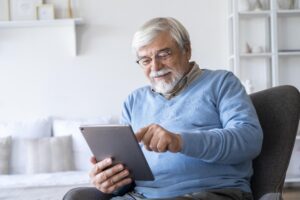older Australian man with tablet choosing care providers