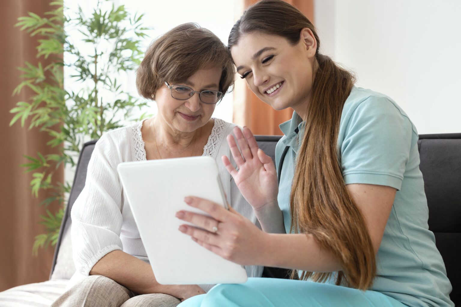 two women looking at care plan on a tablet