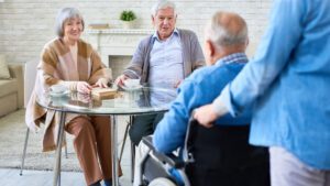 Seniors sitting around a table in an aged care home