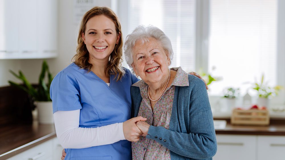 Aged Care worker with elderly woman in kitchen