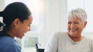 Smiling support at home care worker with older person