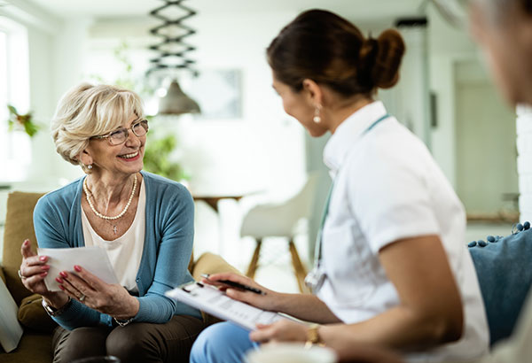 happy-mature-woman-communicating-with-female-doctor-home - Tasmania 